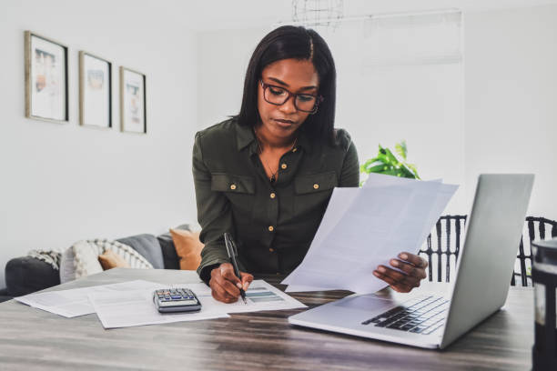 istock Shot of a young businesswoman making notes while working from home 1355265508