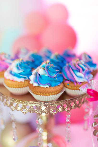 istock blue cupcakes on a golden tray 1355266876