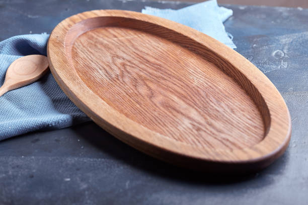 istock Wooden dish or plate on blue rustic wooden table 1355266896