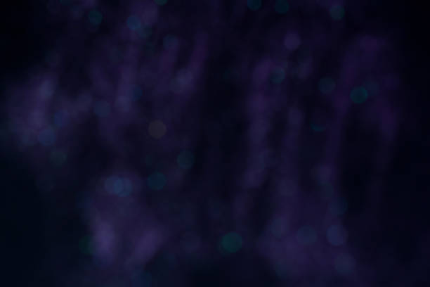 istock Purple festive abstract background with green and blue bokeh 1355269632