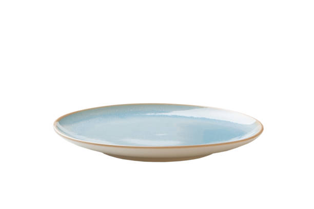 istock Blue ceramic round plate isolated over white background. perspective view 1355270095