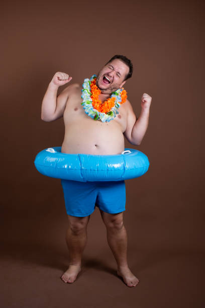 istock Vacation and vacation at sea. Funny fat man. 1355271314