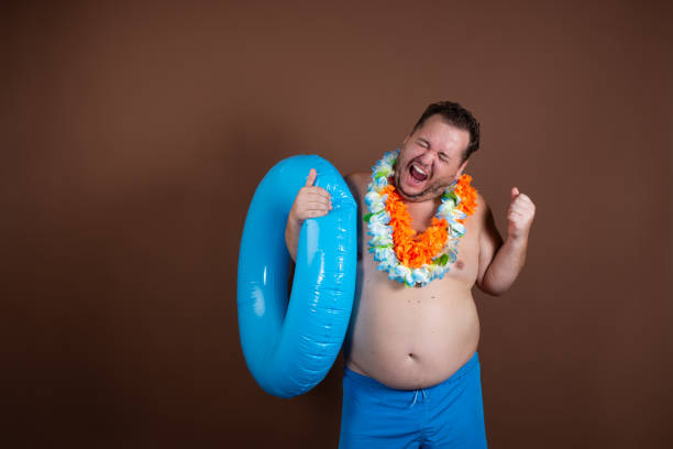 istock Vacation and vacation at sea. Funny fat man. 1355271870
