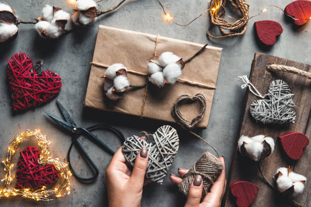 istock Woman preparing gift for wrapping for Valentine's Day 1355274556