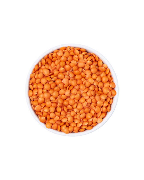 istock Red lentils in white bowl isolated on white background. 1355275464