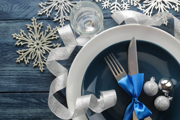 istock Christmas table setting. Knife, fork and plate with new year decorations. on a blue wooden table. view from above . new Year. holidays 1355277765