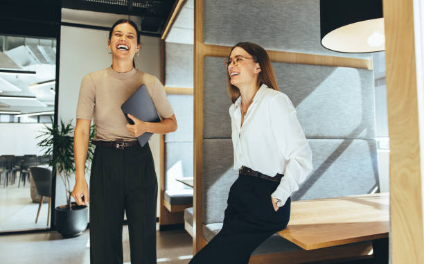 istock Female business professionals laughing in an office 1355278023