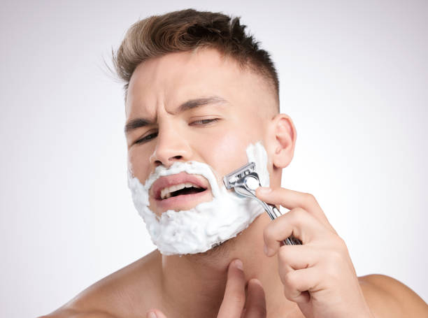 istock Studio shot of a young man shaving his face against a grey background 1355278826