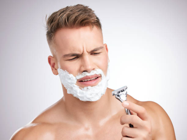 istock Studio shot of a young man shaving his face against a grey background 1355278834