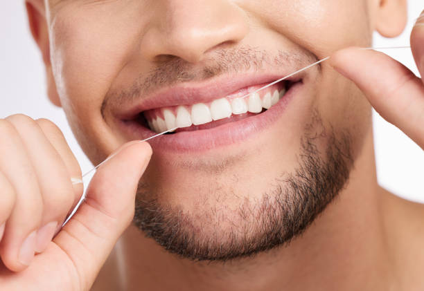 istock Studio shot of an unrecognizable man flossing his teeth against a grey background 1355278852