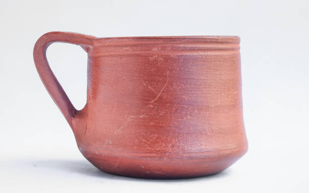 istock Clay made coffee cup with holding handle isolated on white background 1355280418