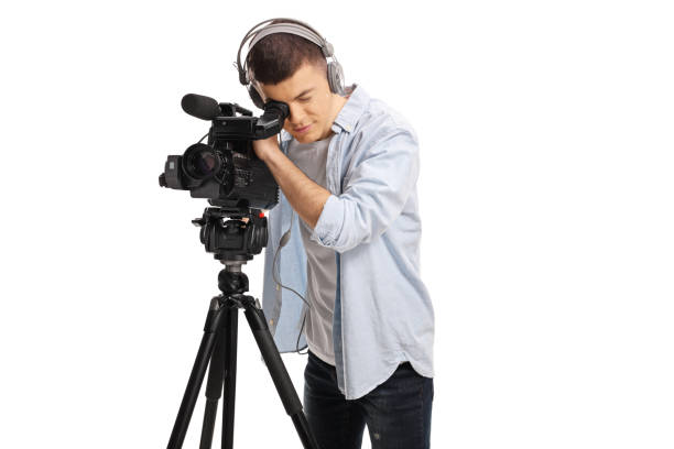 istock Cameraman recording with a camera on a stand 1355281431
