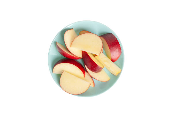 fresh apple slices on a plate isolated on white background. High quality photo