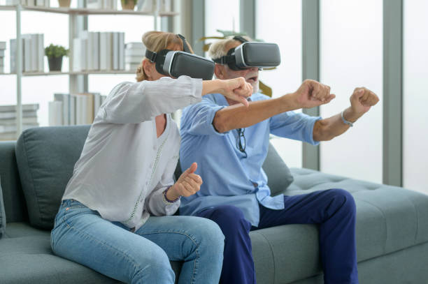istock Caucasian senior couple wearing vr box at home 1355282953