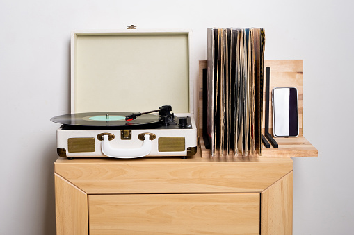 Close up of turntable and shelf with vinyl records