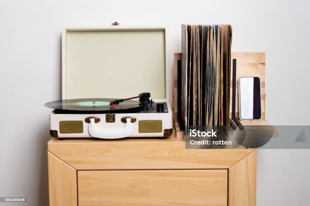 Close up of turntable and shelf with vinyl records Close up of turntable and shelf with vinyl records. High quality photo Turntable Stock Photo