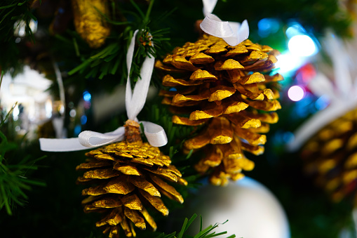 Close up golden pine cones on Christmas tree, Christmas decorations,New year concept.