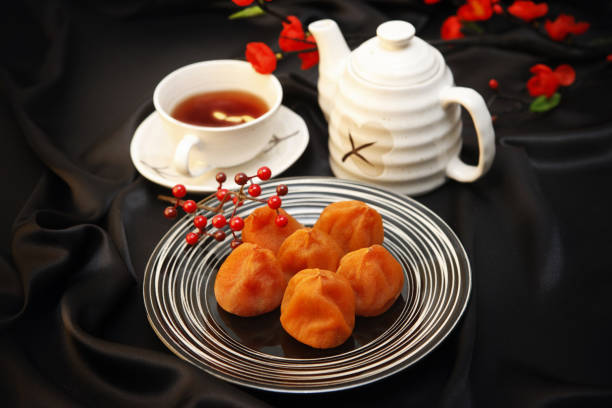 Moist dried persimmon and herbal tea (Sujeonggwa) on a plate
