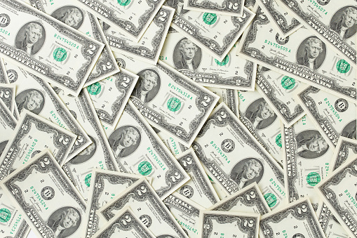 Heap of US two dollar bills as a background, flat lay top view photography