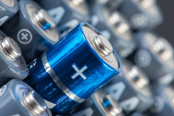 istock Stack of alkaline batteries size AA close up with focus on positive sign 1355291102