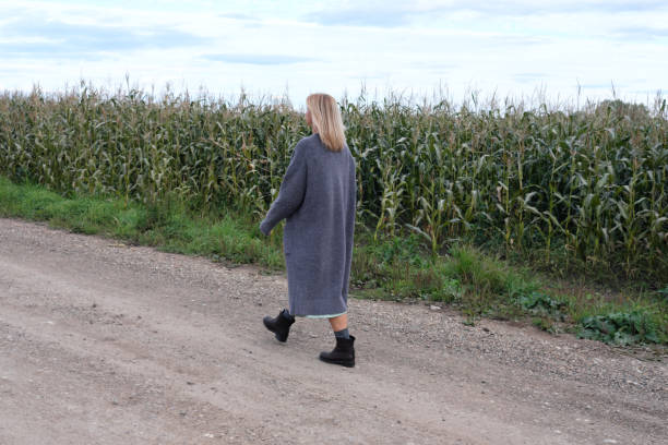 istock Young woman walking at countryside 1355292625