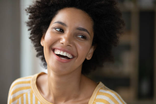 Happy joyful Black girl looking away with toothy smile