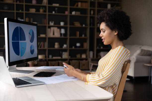 istock Focused female African American employee using mobile phone 1355293371