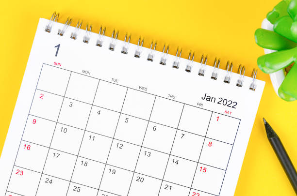 istock January 2022 desk calendar on yellow background. 1355293429