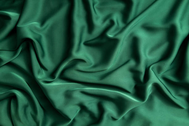 istock Top view of beautiful soft green silk as background.Shiny delicate fabric material 1355294764