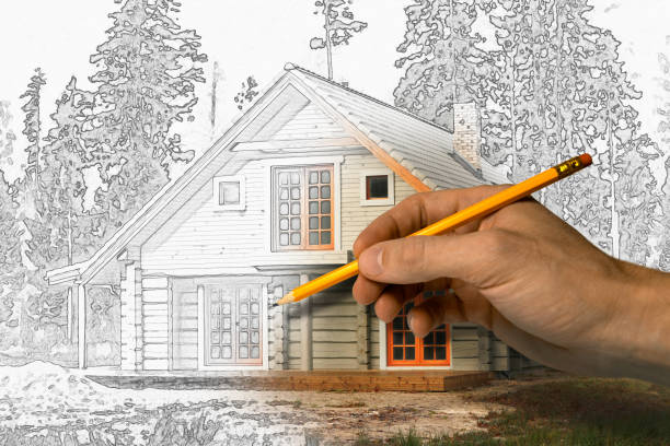 istock house project drawing - architect draws wooden lodge with pencil 1355294789
