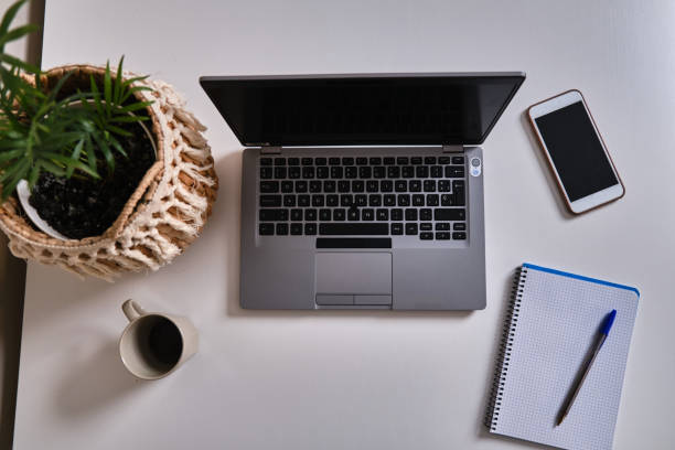 istock work table of a house with laptop 1355295630