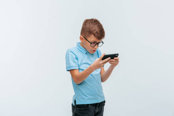 istock kid with glasses who plays games on the internet. 1355295641