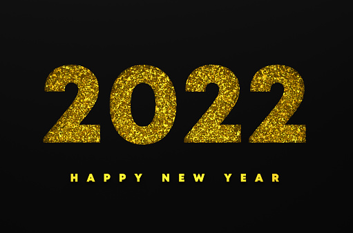 2022 Happy New Year message made of golden color confetti. On black background New Year and Christmas concept.