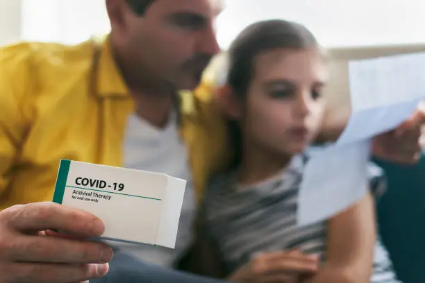 Photo of Father taking care of his sick child. Covid-19 pandemic