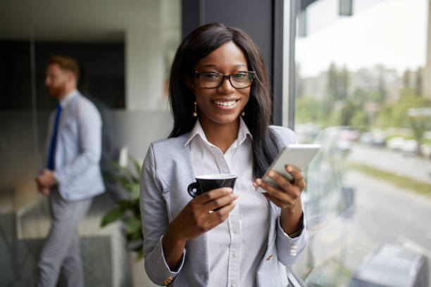 istock Young businesswoman using mobile in the office 1355296319