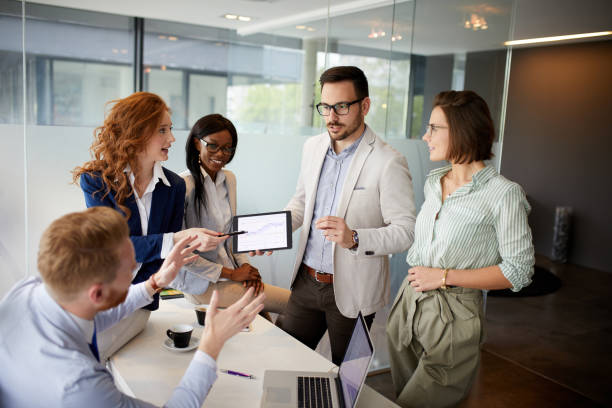 istock Business people discussing new market and sales analysis using digital tablet 1355297216