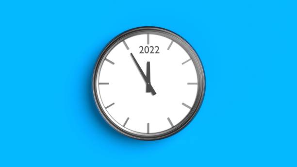 istock Silver Framed Wall Clock on Blue Background For Year 2022 Concept 1355298327
