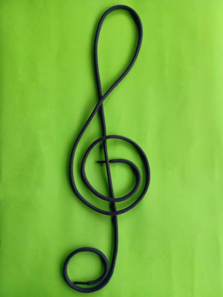 istock Shoelace knot that form a G key on green background 1355298389