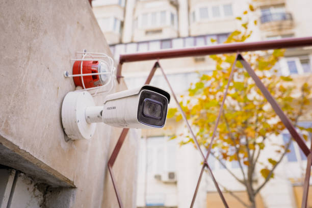 istock Details with a CCTV camera on a wall outside a building. 1355298752