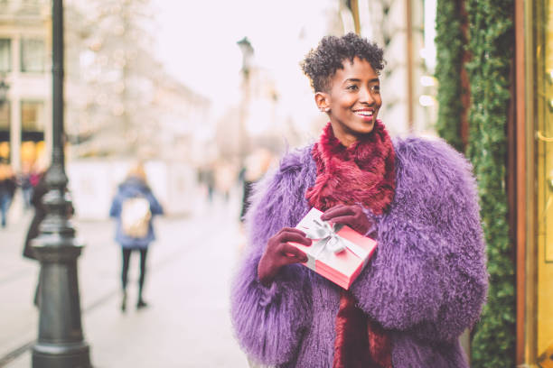 istock Young woman is buying presents 1355298888