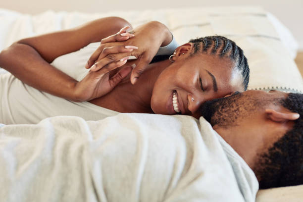 Shot Of A Young Couple Being Intimate In Bed At Home Stock Photo - Download  Image Now - iStock