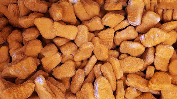 istock Stack Raw Frozen Chicken Nuggets. Several Chicken Nuggets In Breading Close-Up 1355300100