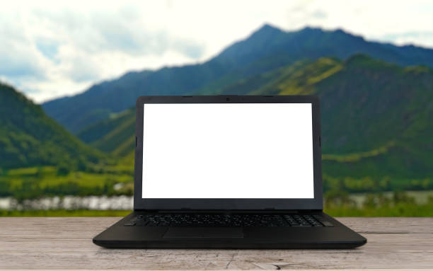 istock blanked screen laptop on aged gray table over blurred mountains background 1355301406