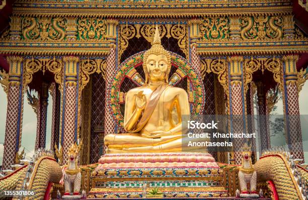 A Golden Buddha Image Sitting In The Posture Of Giving Blessings At Wat Huay Yai Bang Lamung District Stock Photo - Download Image Now