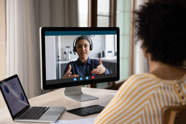 African American customer woman talking to support service employee African American customer woman talking to support service employee, operator on video call. Female business coworkers discussing project marketing report on distance virtual chat at computer monitor recruiter stock pictures, royalty-free photos & images