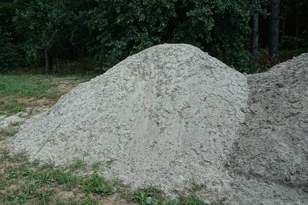 istock one big pile of white sand on green grass 1355304110