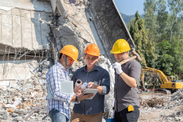 istock Demolition control supervisor and contractor discussing on demolish building. 1355304691