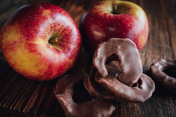 Winter apple with chocolate apple rings on dark wood. Close-up with sweetes for winter and christmas time.