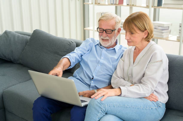 istock Happy Caucasian senior couple using laptop at home 1355306148