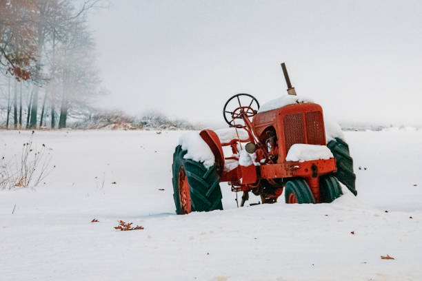 Farmer clearing snow from driveway in rural Iowa